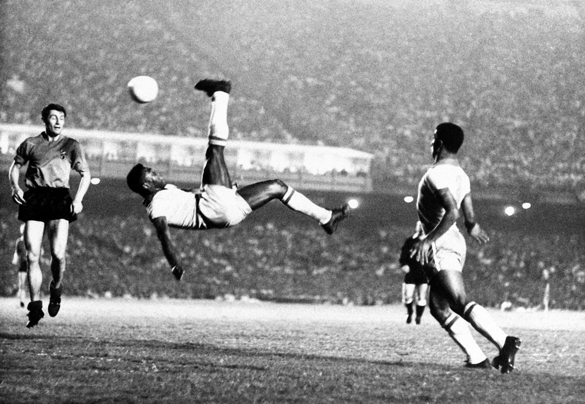 In this Sept. 1968 file photo, Brazil's Pele kicks the ball during a friendly soccer game against Belgium.
