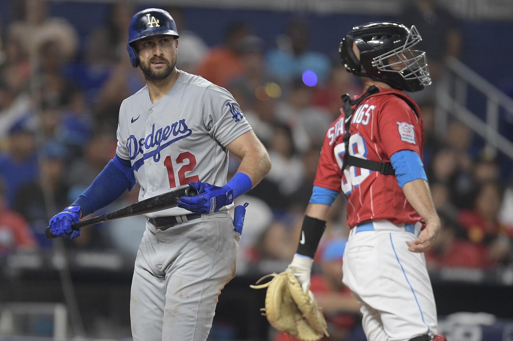 Dodgers batter Joey Gallo walks past Miami Marlins catcher Jacob Stallings after striking out.