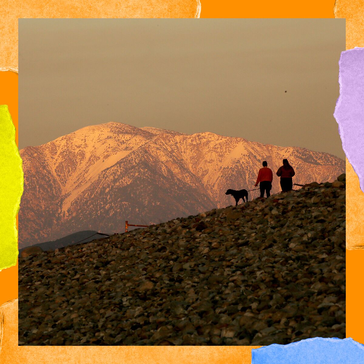 People walk with a dog on the San Gabriel River trail at the Santa Fe Dam in Irwindale on Monday, Dec. 19, 2022.