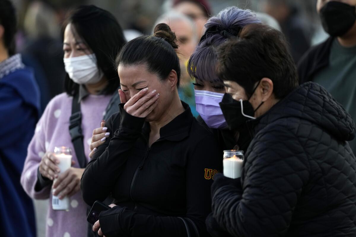 People attend a vigil outside Monterey Park City Hall.