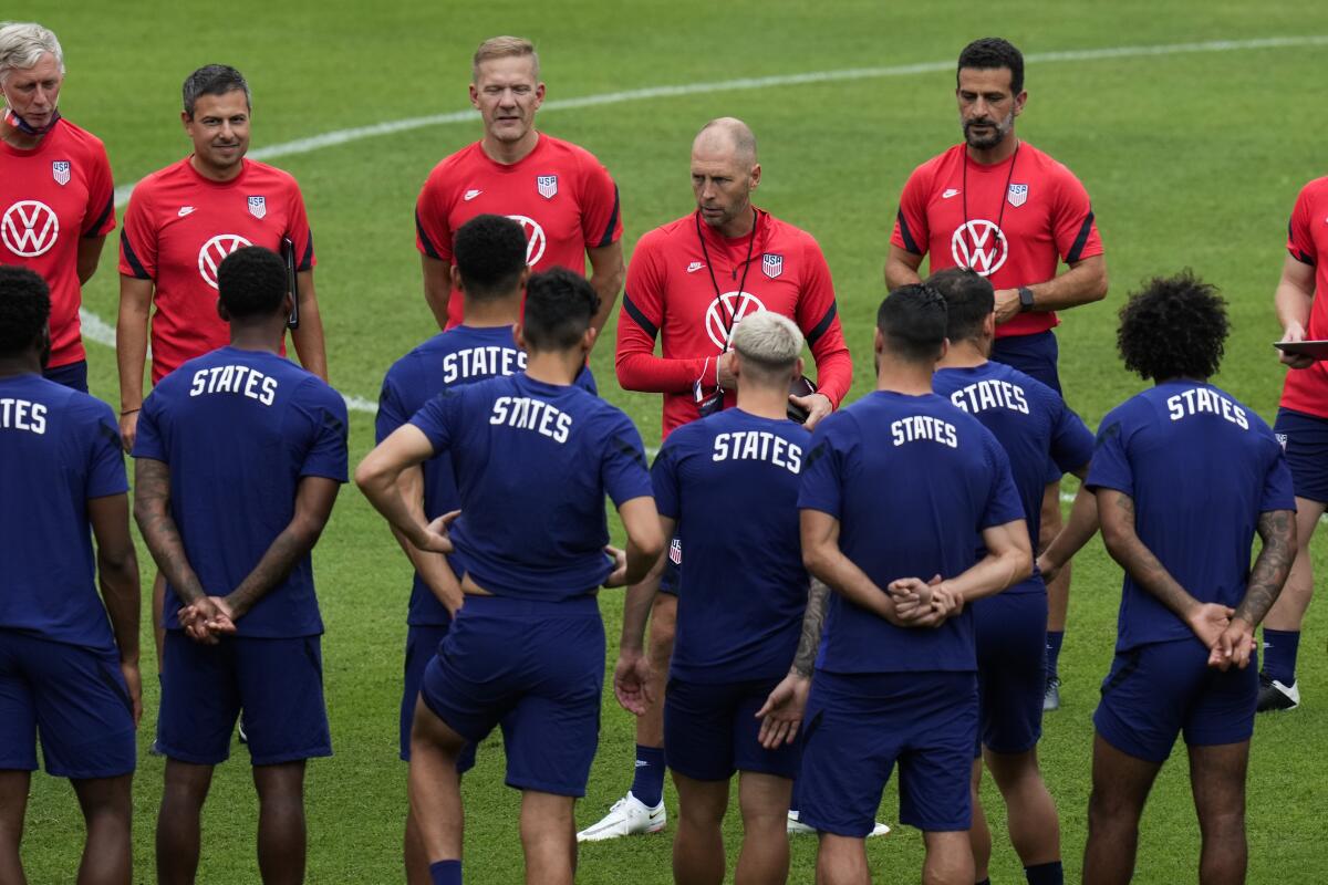 U.S. men's soccer coach Gregg Berhalter, center, talks with players.