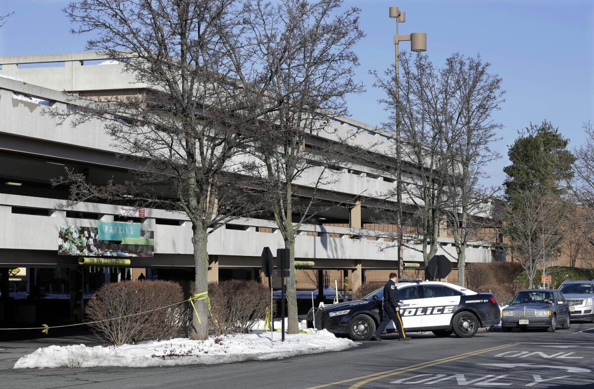 A police officer arrives on Monday at a parking garage at The Mall at Short Hills in Short Hills, N.J. where a fatal carjacking took place.