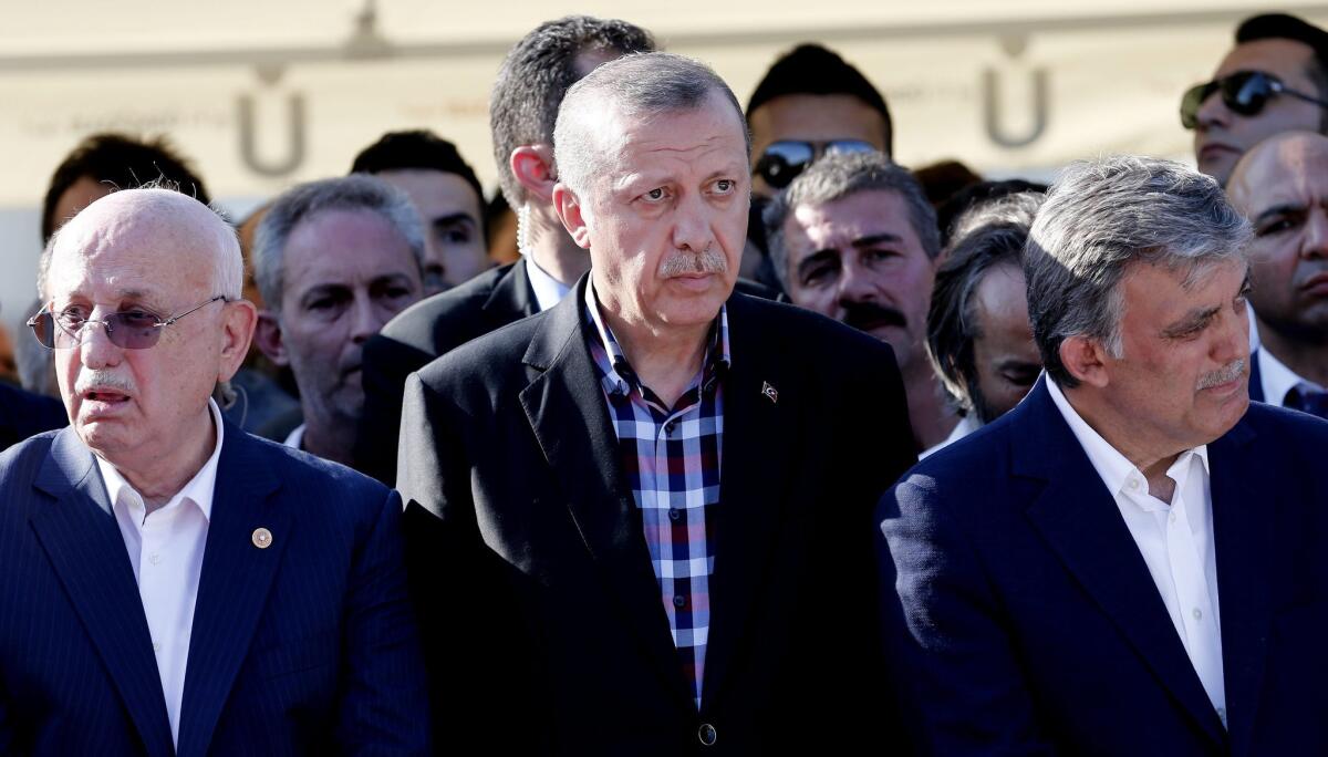 Turkish President Recep Tayyip Erdogan (center), along with the nation's current parliamentary speaker Ismail Kahraman (left) and former president Abdullah Gul (right), attends a funeral in Istanbul for some of those killed in last week's coup attempt.