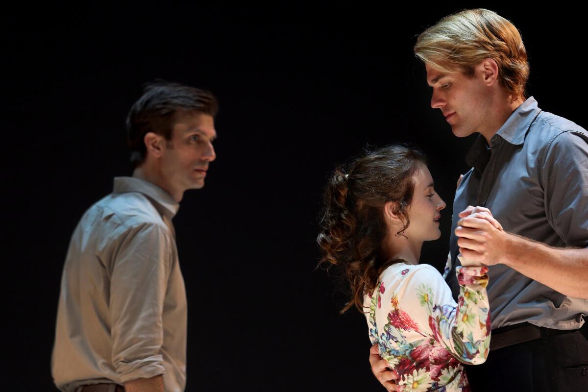 Eddie (Frederick Weller) looks on as Catherine (Catherine Combs) is held by Rodolpho (Dave Register) during Ivo van Hove's production of Arthur Miller's "A View From the Bridge" at the Ahmanson Theatre.