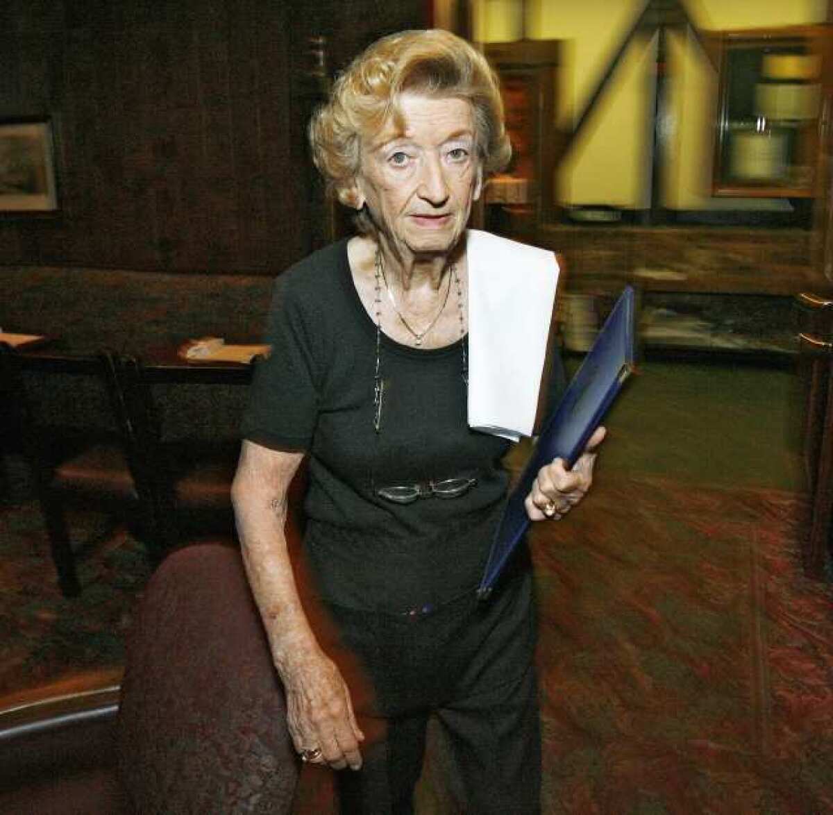Antonia Becerra, 81, of Glendale, working at Taix in Los Angeles on Friday, September 28, 2012, where she has worked since 1968. Becerra fell victim to a Nigerian scam and lost $45,000, her life savings.