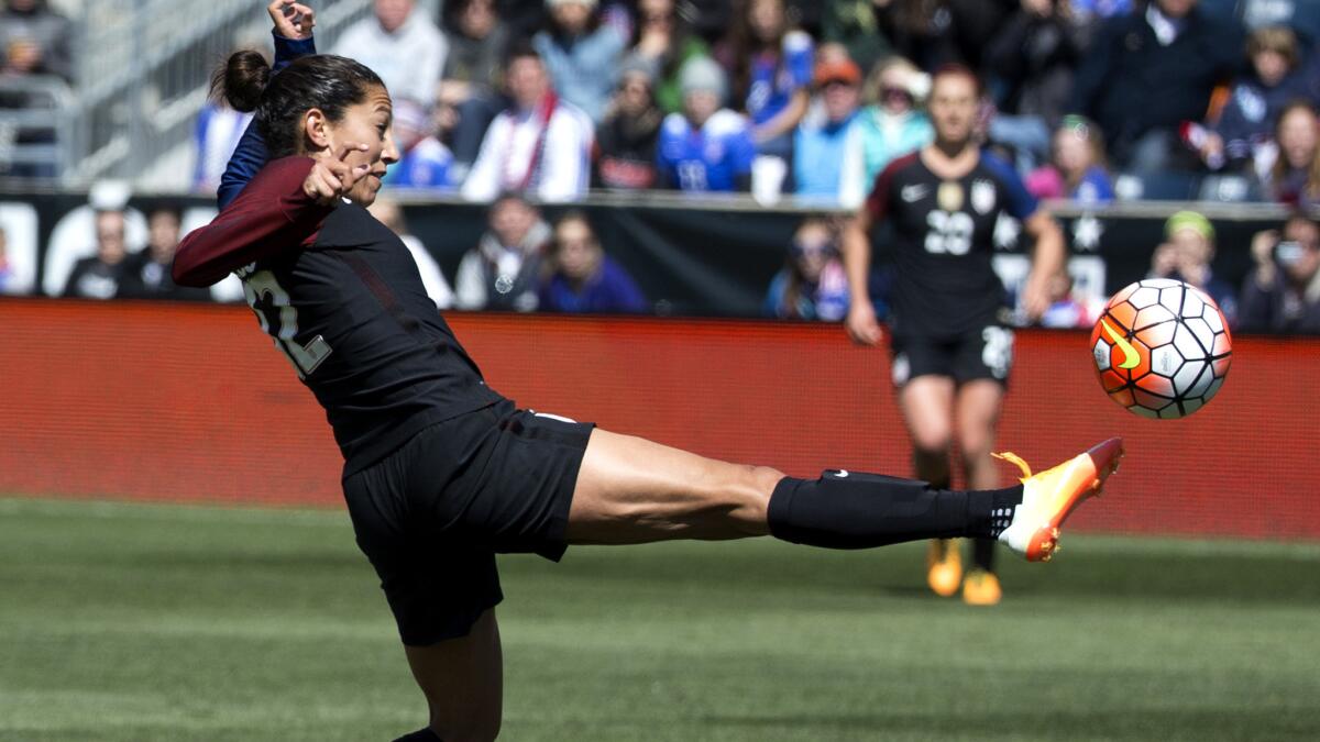 U.S. forward Christen Press volleys a shot into the goal against Colombia during the first half Sunday.