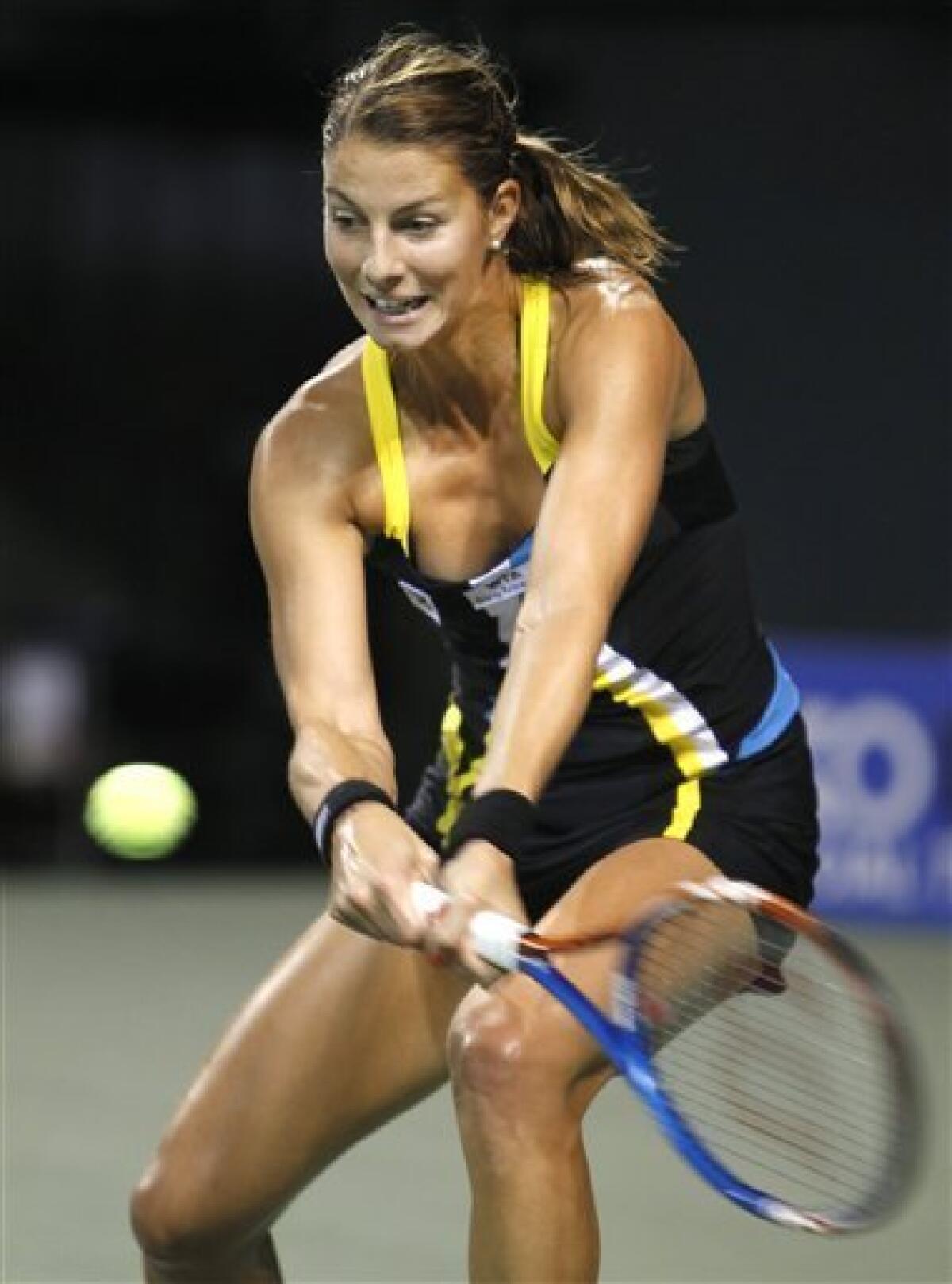 Mandy Minella of Luxembourg returns a ball to Kimiko Date-Krumm of Japan during their first round match of the Japan Pan Pacific Open tennis tournament in Tokyo, Monday, Sept. 26, 2011. Minella won 1-6, 6-3, 6-3.(AP Photo/Shizuo Kambayashi)