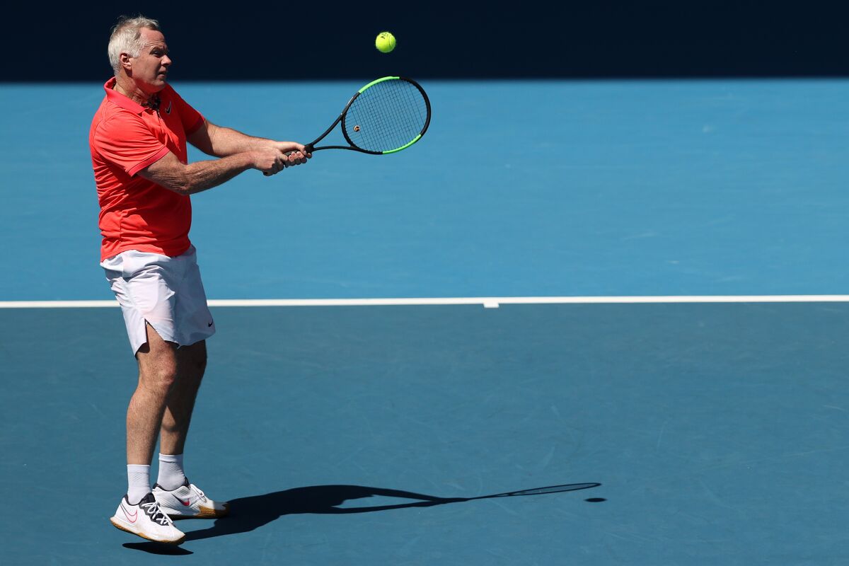 Patrick McEnroe plays a backhand during a men's legends doubles match with brother John McEnroe at the Australian Open in January.