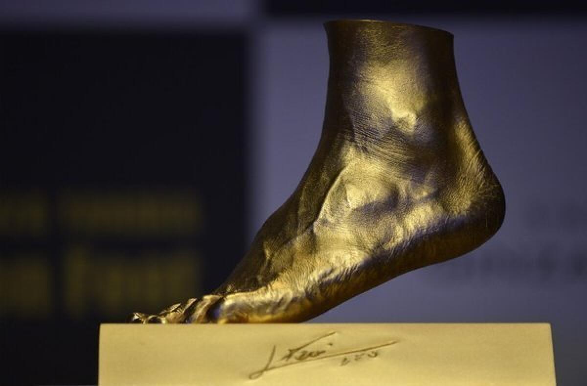 A pure gold replica of Lionel Messi's left foot, priced at $5.25 million, is unveiled in Tokyo.