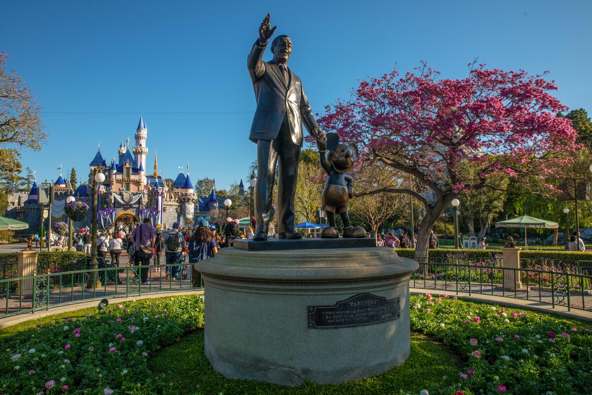 A statue of Walt Disney and Micky Mouse greet visitors to Disneyland.