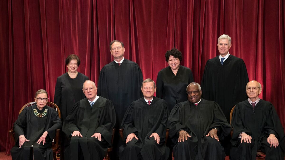 The justices of the U.S. Supreme Court gather for an official group portrait to include new Associate Justice Neil Gorsuch, top row, far right, Thursday. June 1, 2017, at the Supreme Court Building in Washington.