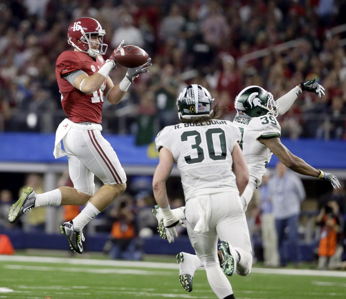 Alabama receiver Richard Mullaney makes a catch over Michigan State linebacker Riley Bullough (30) and cornerback Jermaine Edmondson (39) during the first half of the Cotton Bowl on Dec. 31.