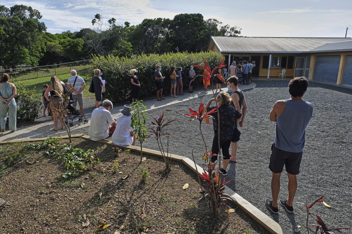 People queue outside a school to vote in a referendum in Noumea, New Caledonia