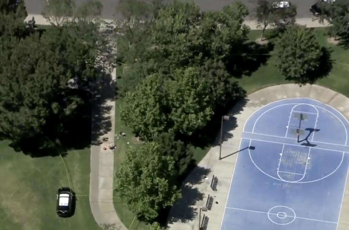 An aerial photograph shows a basketball court and park in Rialto.