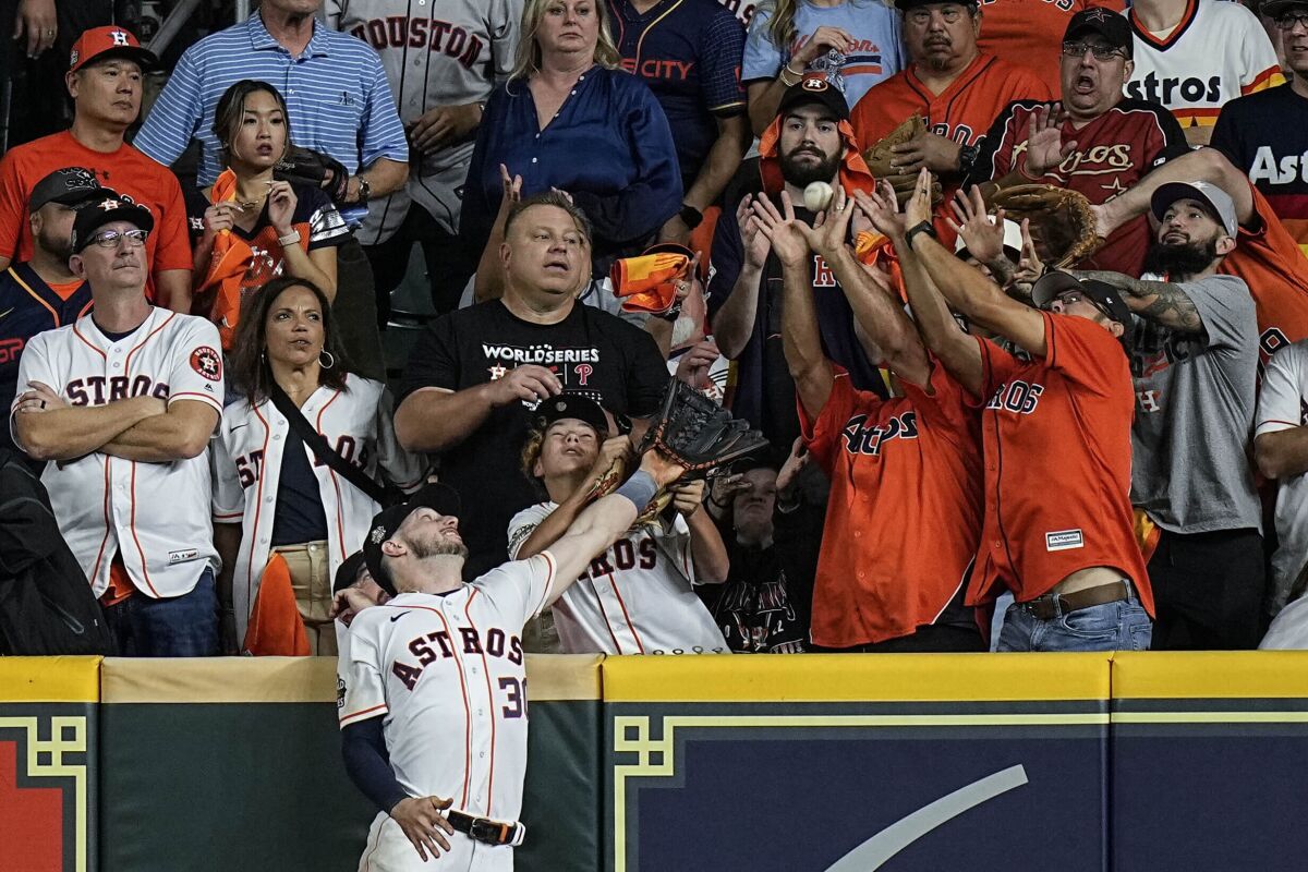 Houston Astros right fielder Kyle Tucker can't get a glove on a home run by Philadelphia's JT Realmuto.