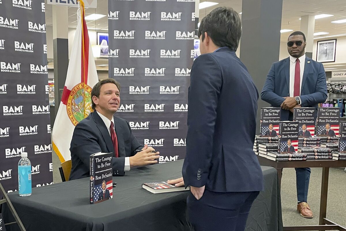 Florida Gov. Ron DeSantis greets supporters at a book signing event, Thursday, March 23, 2023 in Tallahassee, Fla. Allies of DeSantis are gaining confidence in his White House prospects as former President Donald Trump’s legal woes mount. Trump is facing possible criminal charges in New York, Georgia and Washington as he runs for president again. (AP Photo/Steve Peoples)