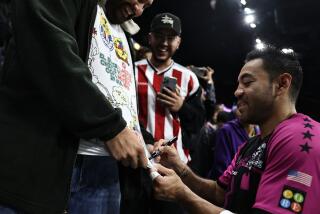 Empire Strykers midfielder Marco Fabian signs autographs during a game on Dec. 15, 2023.
