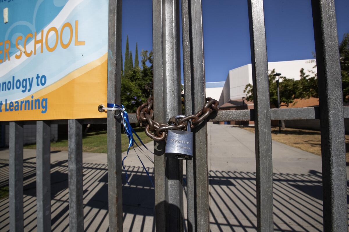 A locked gate in front of Los Angeles High School.