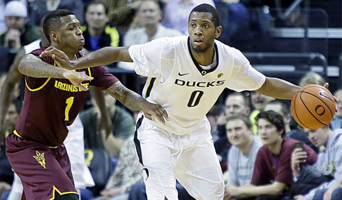 Oregon forward Mike Moser, right, dribbles against Arizona State guard Jahii Carson on March 4.