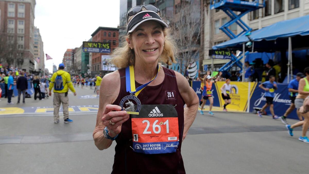 Kathrine Switzer, 70, displays her medal after finishing the 121st Boston Marathon on April 17.