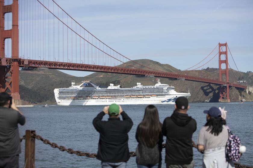 The Grand Princess sails under the Golden Gate Bridge in San Francisco on its journey on Monday to the Port of Oakland, where the cruise ship’s passengers would face additional screenings for the coronavirus.