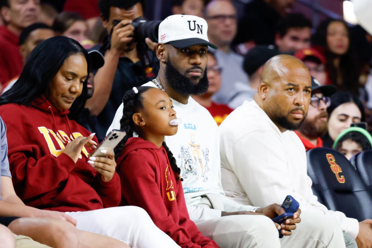 Lakers' Lebron James watches son Bronny James play during the first half of USC's game against Long Beach State.