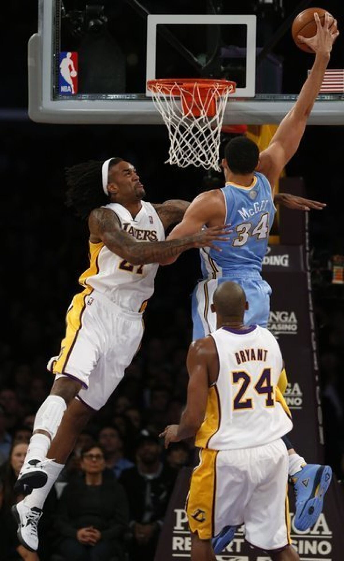Nuggets center JaVale McGee misses a dunk attempt over Jordan Hill in the first half of game Jan. 6, during which Hill was injured.