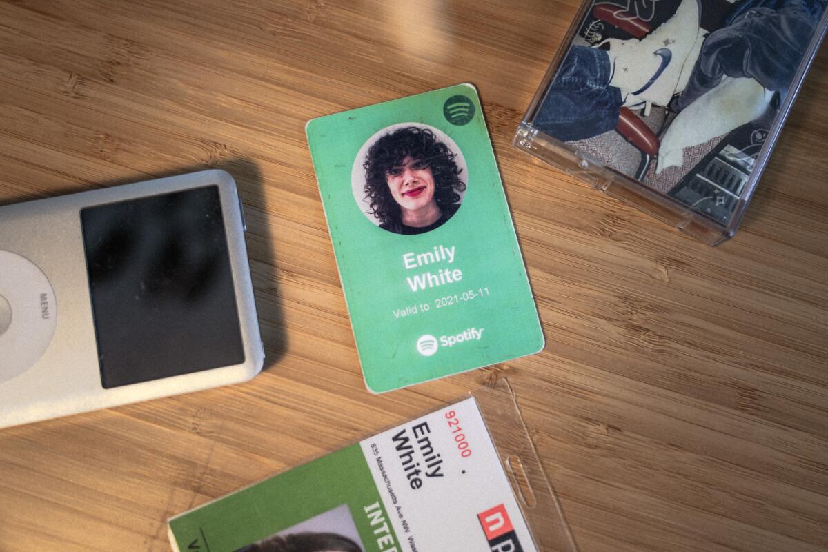 Emily White's Spotify employee ID card, NPR intern ID card, Apple iPod and a cassette tape. 