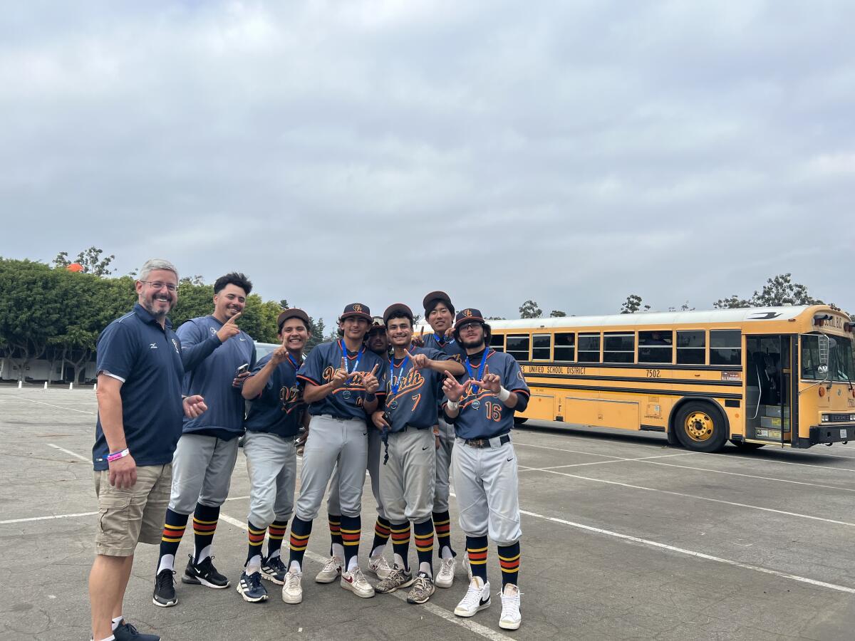 Chatsworth players standout outside their disabled school bus at Dodger Stadium