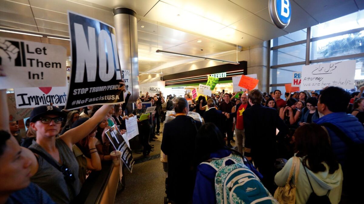 People protest President Trump's travel ban at Los Angeles International Airport on Sunday.