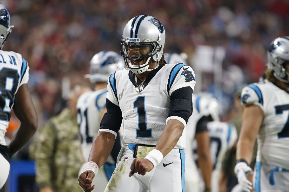 Carolina Panthers quarterback Cam Newton celebrates after a Panthers touchdown against the Arizona Cardinals during the second half of an NFL football game Sunday, Nov. 14, 2021, in Glendale, Ariz. (AP Photo/Ralph Freso)