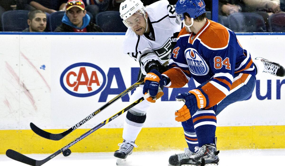 Kings center Trevor Lewis and Oilers defenseman Oscar Klefbom try to gain possession of the puck during a March 3 game in Edmonton, Canada.