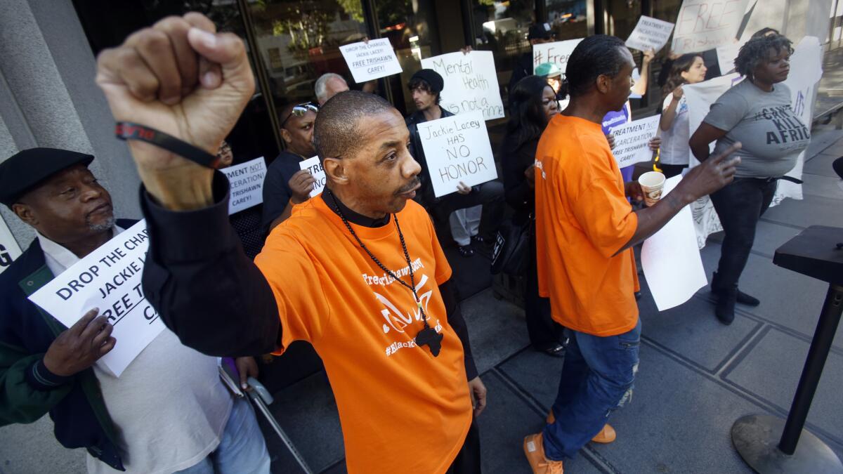 Activists protest charges against Trishawn Carey, a homeless woman accused of picking up a police baton during a 2015 skid row confrontation that ended with the fatal police shooting of Charly "Africa" Keunang.