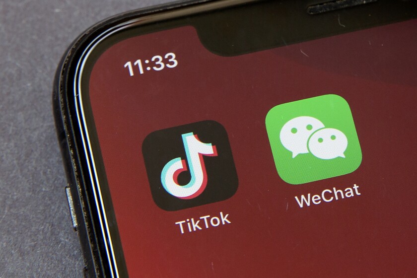 Icons for the smartphone apps TikTok and WeChat are seen on a smartphone screen.