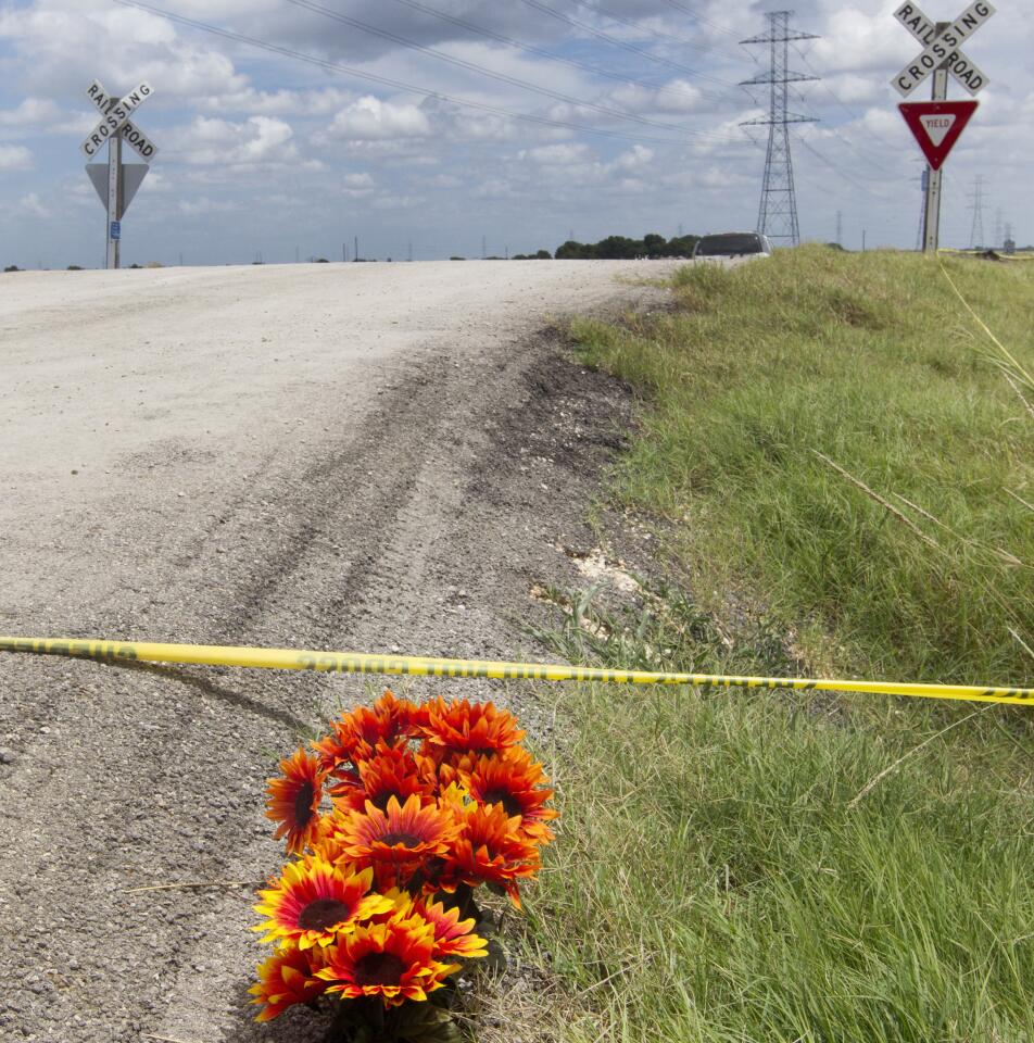 Flowers sit next to police tape at the site of a hot air balloon crash near Lockhart, Texas, on July 31, 2016.