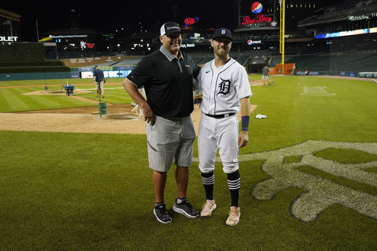 Roger Clemens, seven-time Cy Young Award winning pitcher, left, poses with his son Kody Clemens after the second baseball game of a doubleheader against the Minnesota Twins, Tuesday, May 31, 2022, in Detroit. Kody made his debut with the Tigers in the major leagues. (AP Photo/Carlos Osorio)