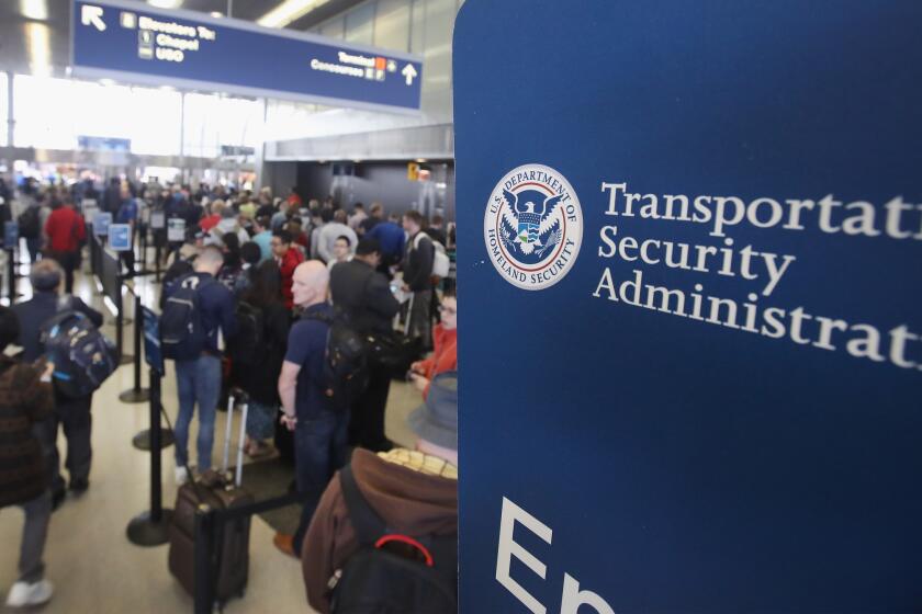 Passengers at Chicago's O'Hare International Airport wait in line to be screened at a TSA checkpoint on May 16.