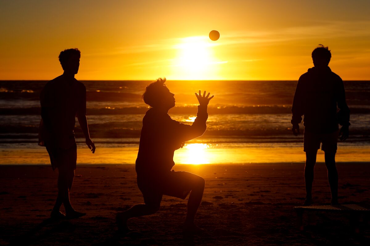  Jacob Van Every, of San Jose, Will Rainey, of San Jose, and Dominic Bradley, of Modesto, play spike ball at Pacific Beach 