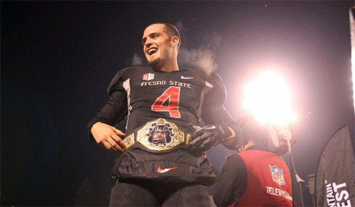 Fresno State quarterback Derek Carr celebrates winning the Mountain West title with a win over Utah State, 24-17, on Dec. 7. Carr and the Bulldogs will face USC in the Las Vegas Bowl on Dec. 21.