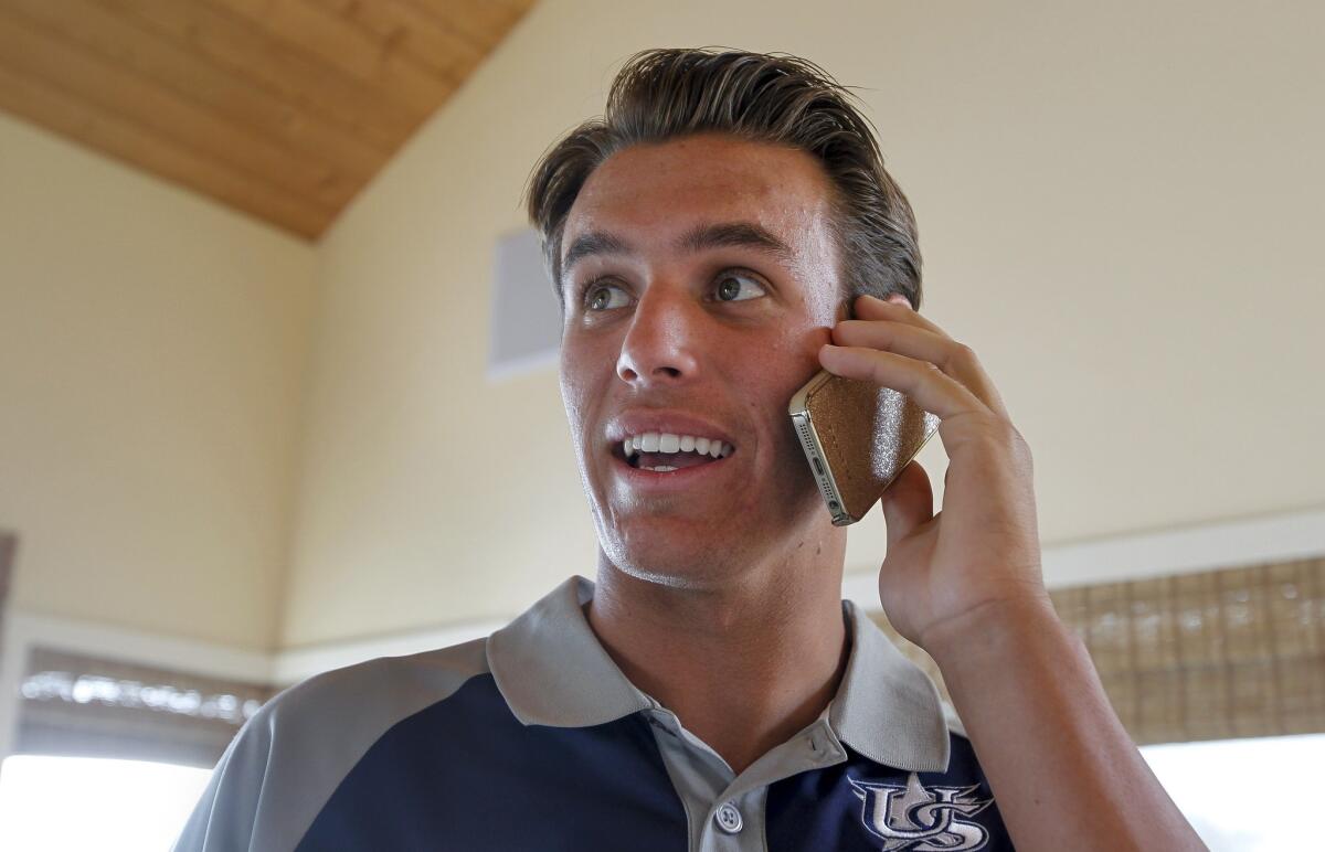 Brady Aiken watches the MLB draft as he receives a congratulatory phone call just after he was selected by the Houston Astros as the first pick on June 5, 2014.