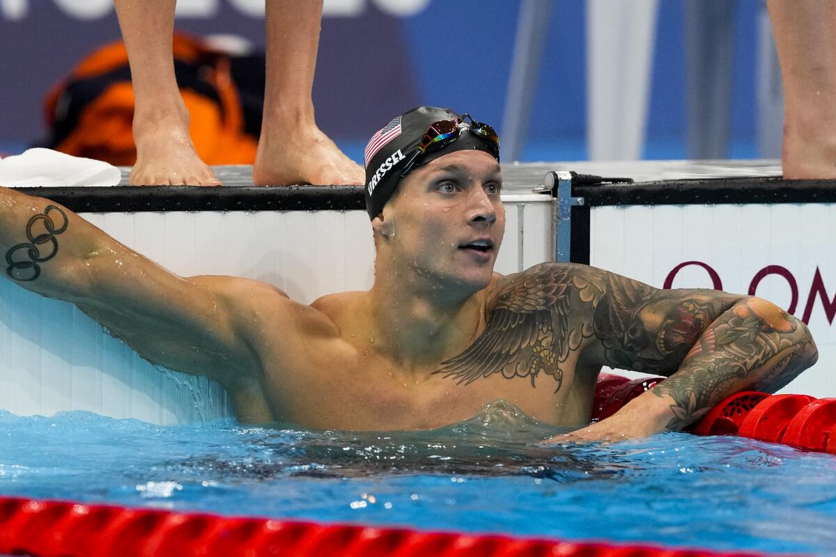 U.S. swimmer Caeleb Dressel looks at the scoring board after a qualifying heat.