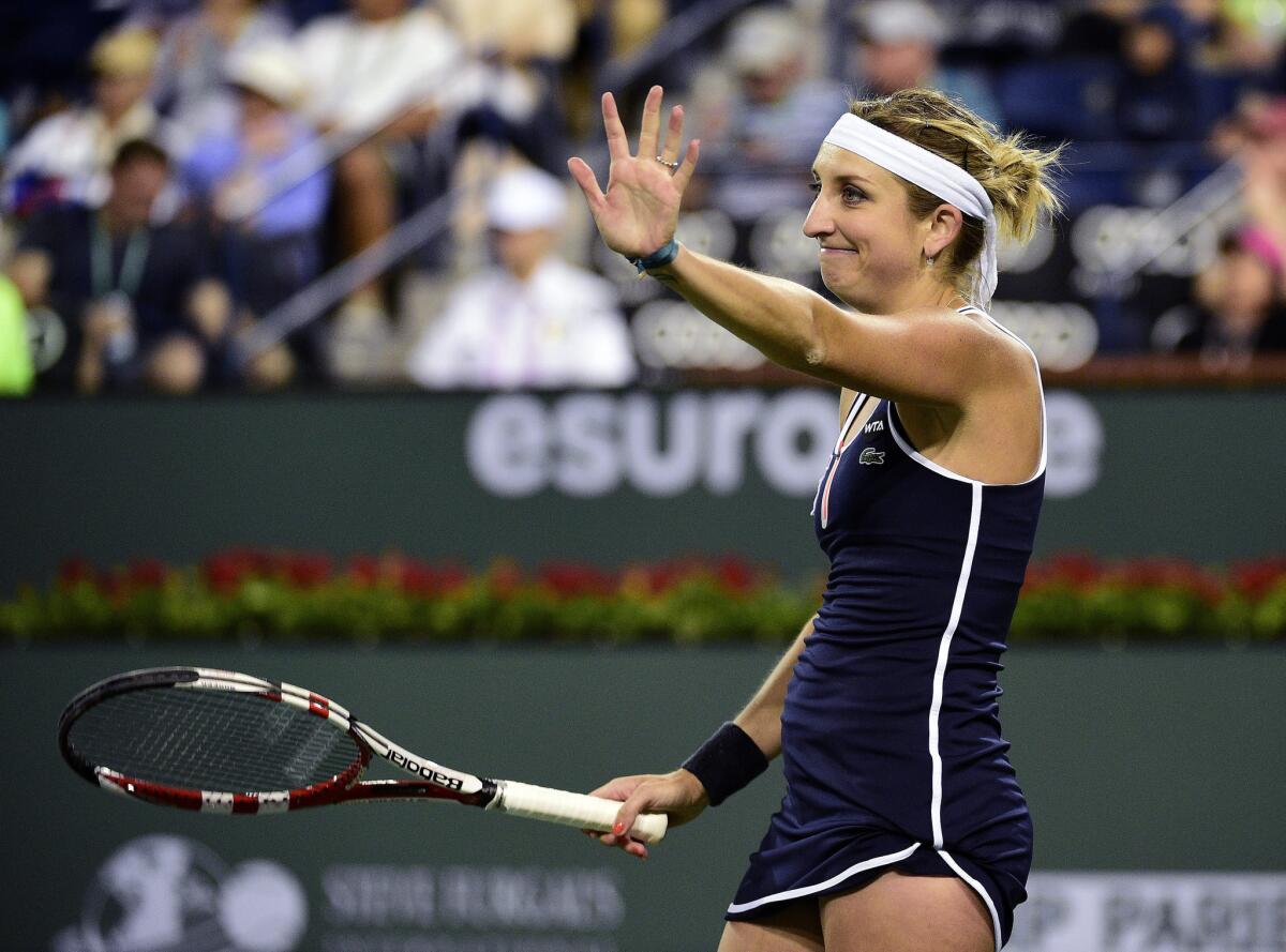 Timea Bacsinszky reacts during her match against Serena Williams in the BNP Paribas Open tennis tournament in Indian Wells, Calif.