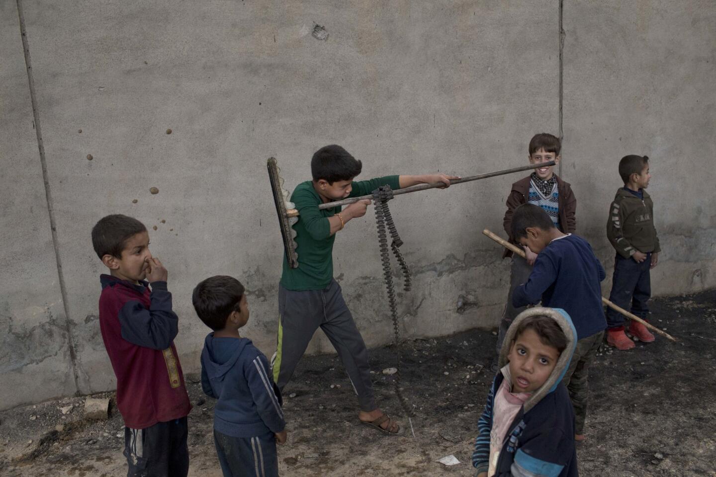 Children play in Qayara, some 50 kilometers south of Mosul, Iraq, on Nov. 10, 2016. Iraqi troops consolidated gains in their advance on the northern city of Mosul on Thursday, regrouping as they clear neighborhoods and houses once occupied by the Islamic State group.