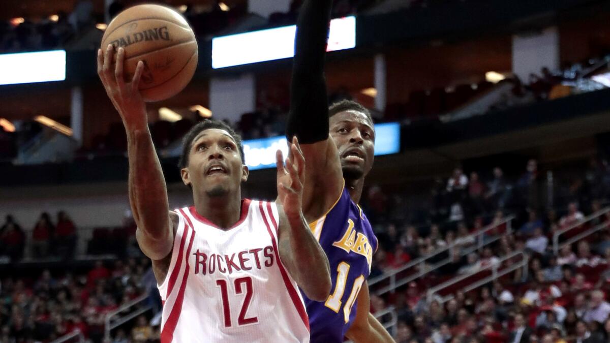 Rockets guard Lou Williams attempts a layup against David Nwaba of the Lakers during a game at Houston on Wednesday night. Williams finished with 30 points.