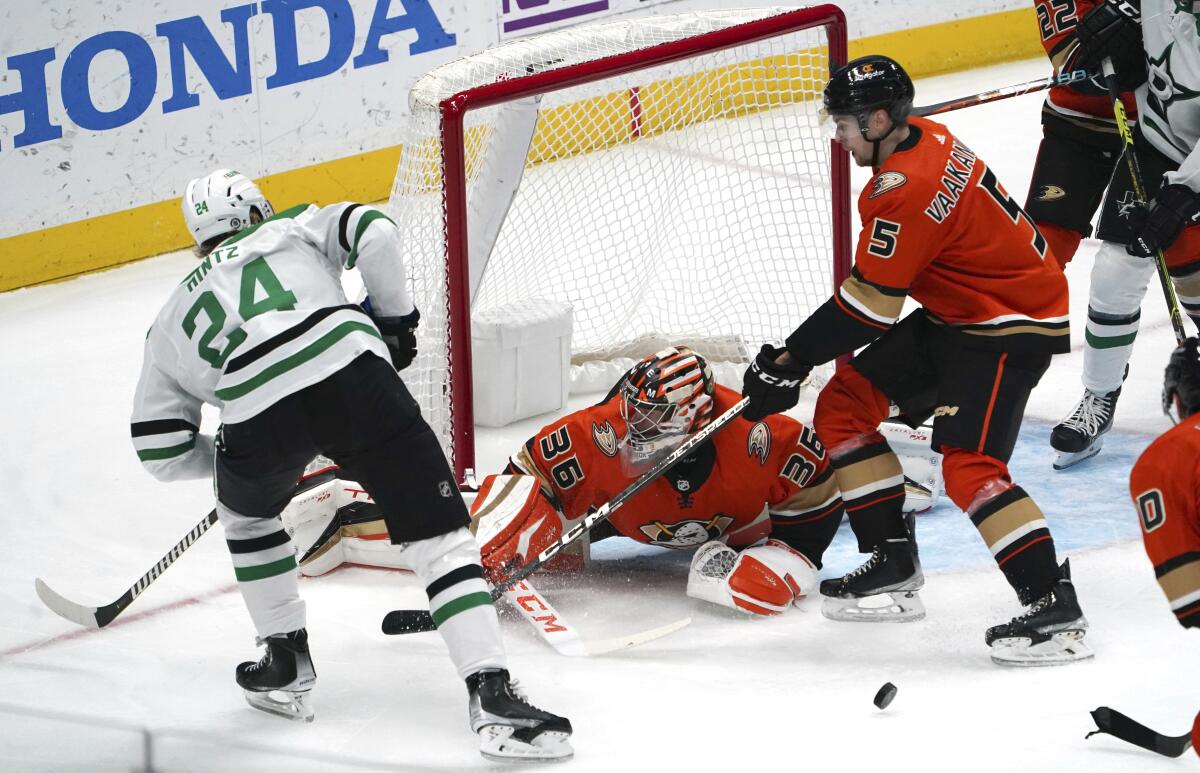 Ducks goaltender John Gibson and defenseman Urho Vaakanainen defend against Dallas Stars center Roope Hintz.