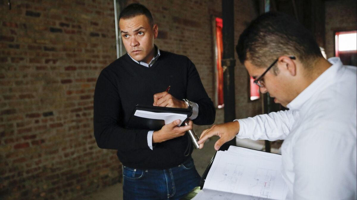 Recent college graduate Gabriel Villagomez, left, has an internship with real estate broker and consultant Miguel Chacon, but he's worried about what he'll do when his student loans start coming due.