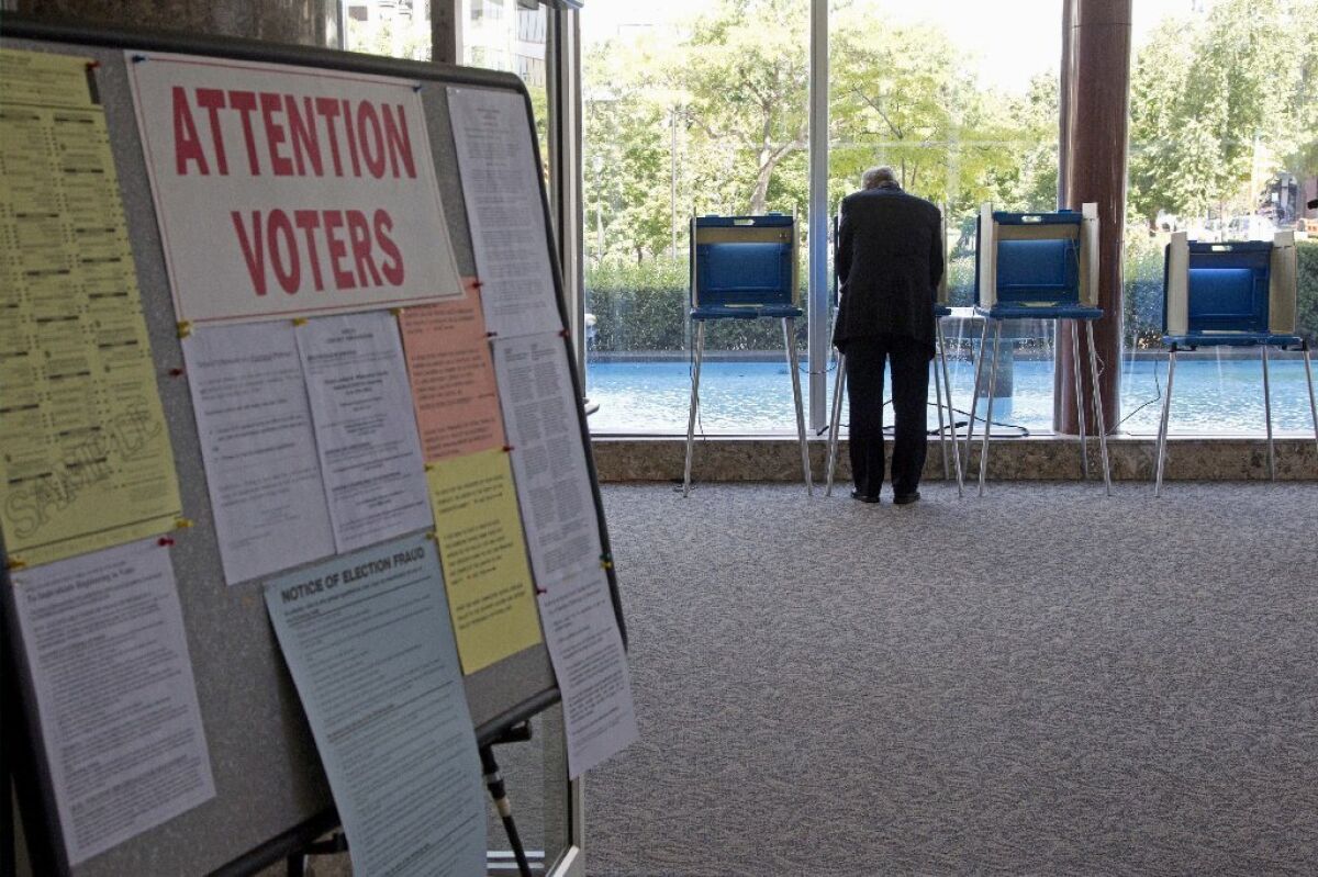A lone voter takes part in early voting in Milwaukee. In October, the U.S. Supreme Court blocked Wisconsin's voter ID law.
