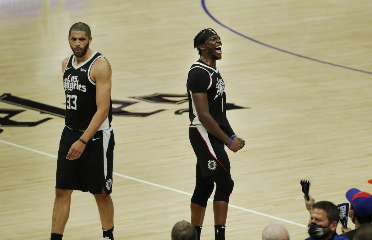 Clippers forward Nicolas Batum, left, and guard Reggie Jackson react late in the game of a series-clinching win over Utah.
