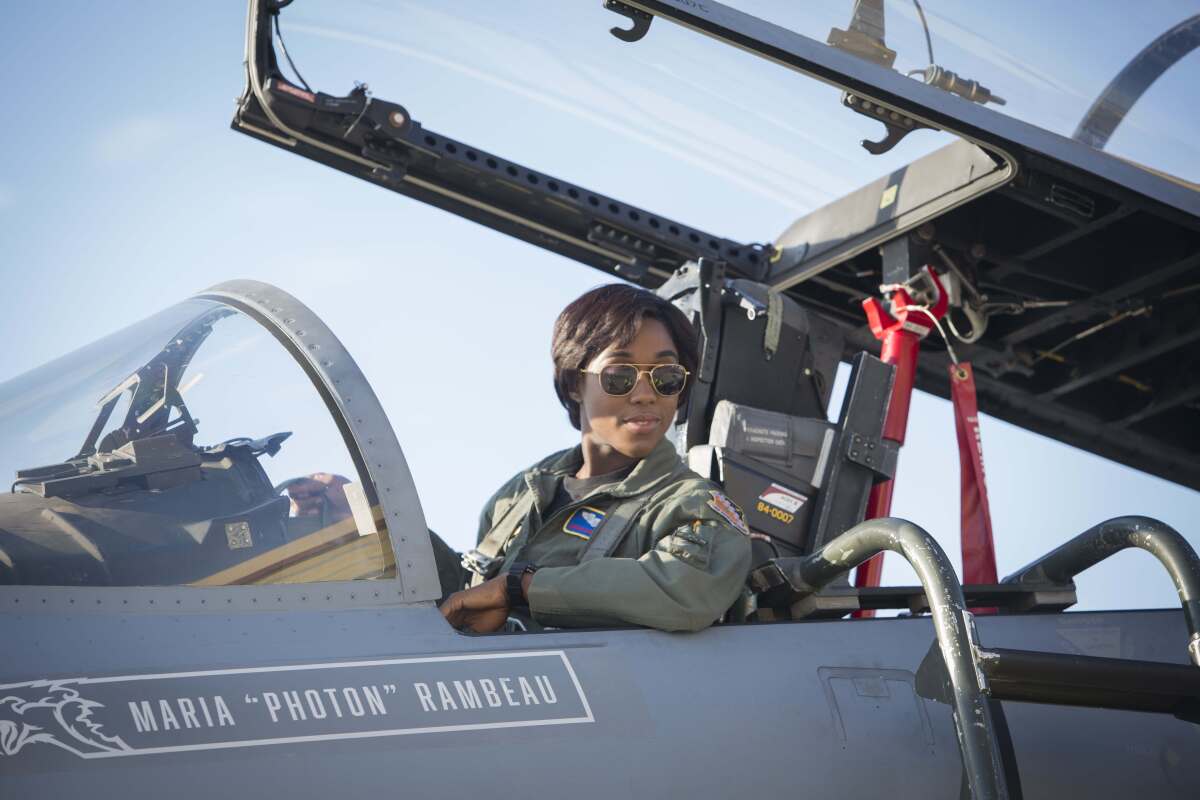 a woman in a cockpit of a jet