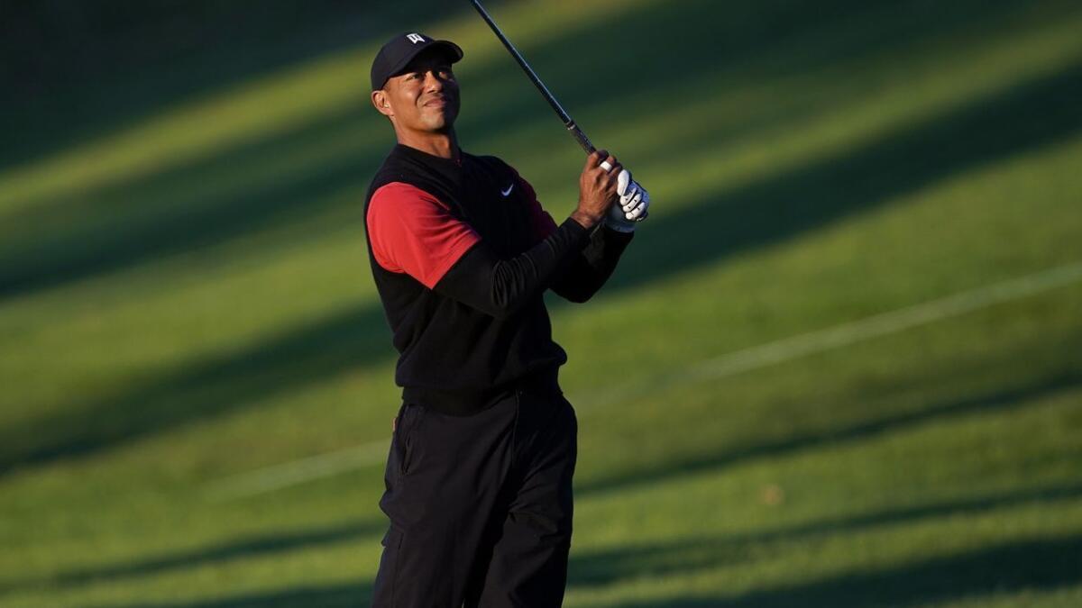 Tiger Woods hits his second shot on the 18th hole during the third round of the Genesis Open at Riviera Country Club on Sunday morning.